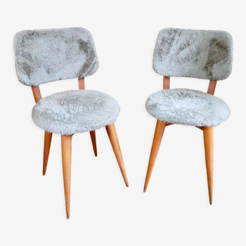 Pair of moumoute chairs with compass feet