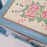 Blue wooden bedside tables with floral patterns
