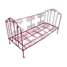 Old bed in red wrought iron