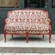 Antique salon with a banquette and Louis XV style bergère chairs.
