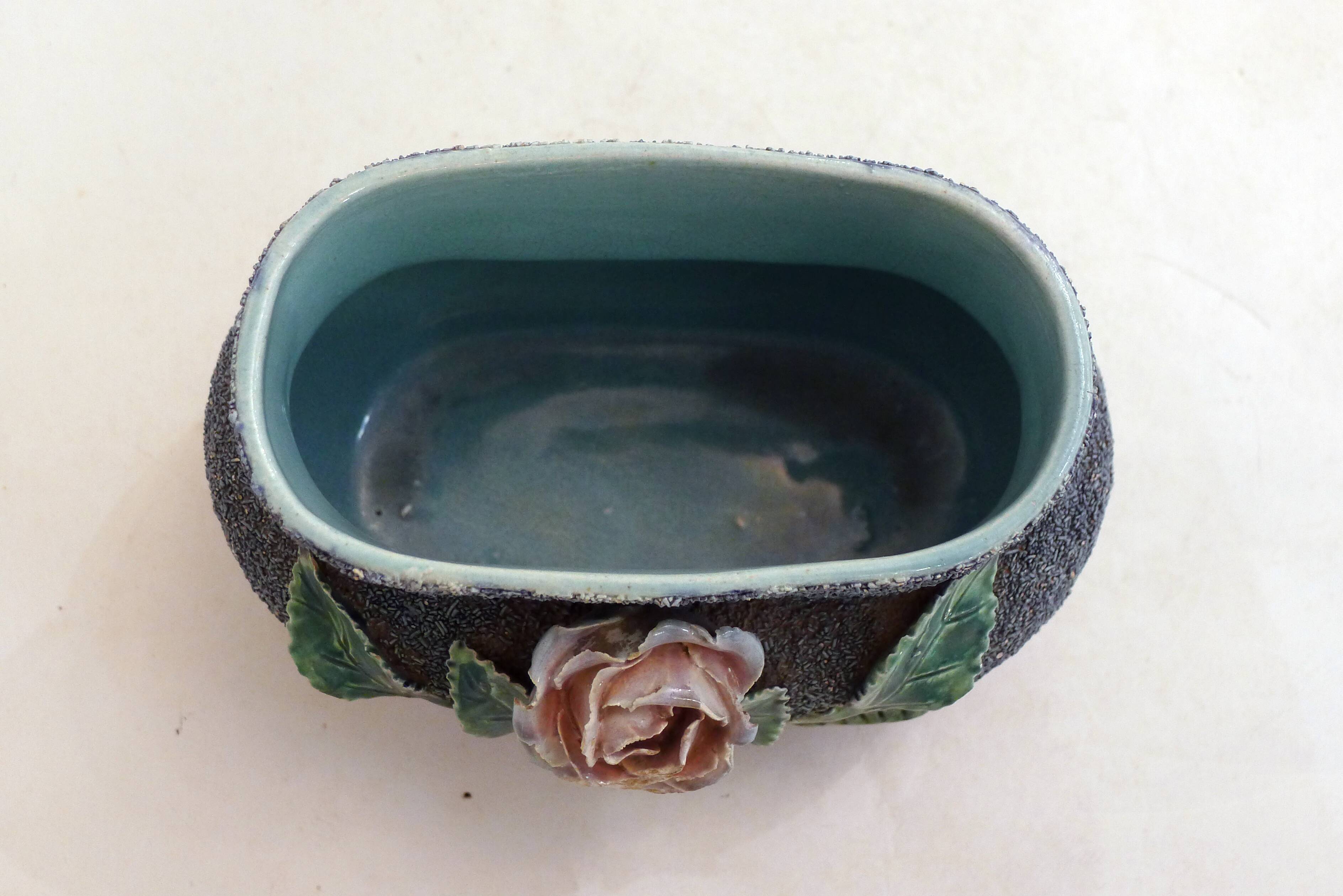 Antique jardinière with rose design in barbotine pottery.