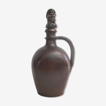 Sandstone pitcher, with anthropomorphic cap.