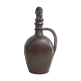 Sandstone pitcher, with anthropomorphic cap.