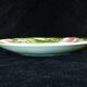 Plate in slurry with strawberry decoration and strawberry leaf