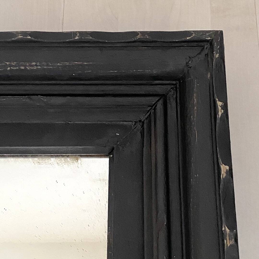 1950s mirror, matte black wood with a patina.