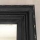 1950s mirror, matte black wood with a patina.