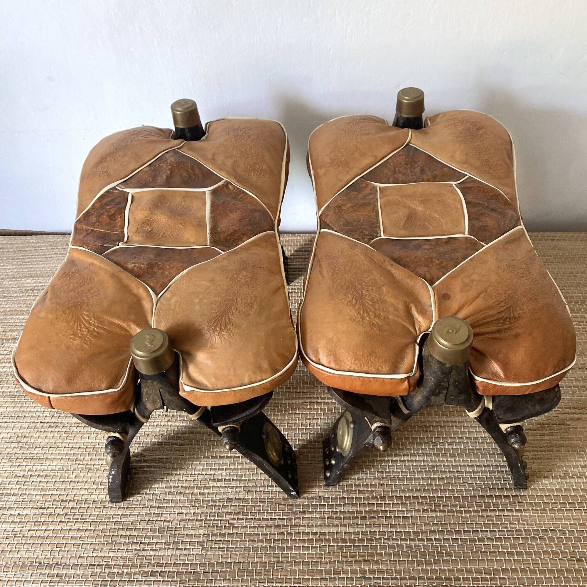 Pair of low Egyptian stools, camel saddles in wood, leather and brass