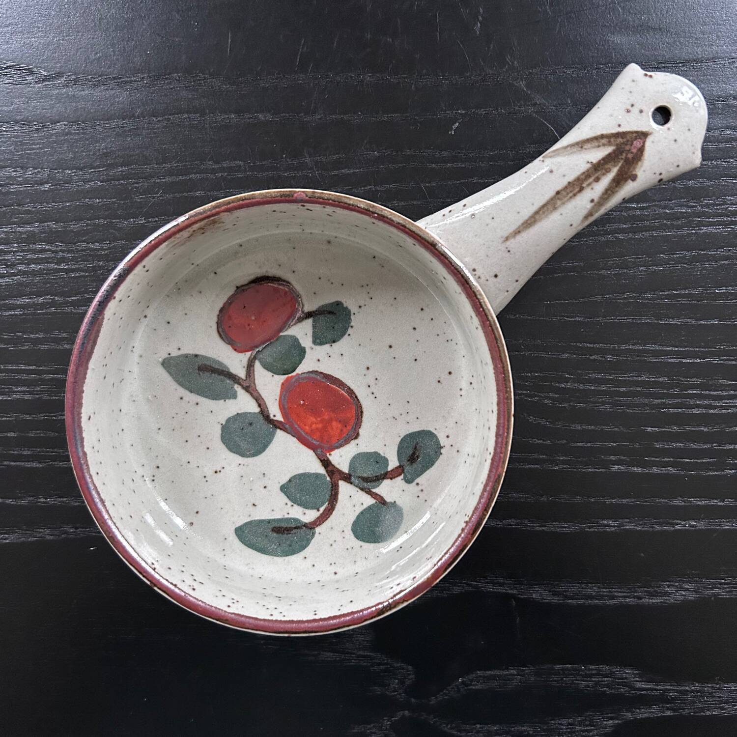 Frying pan with red fruit decoration