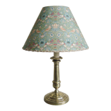 Brass candlestick lamp with its fabric lampshade by William Morris