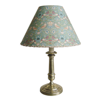 Brass candlestick lamp with its fabric lampshade by William Morris