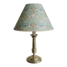 Brass candlestick lamp with its fabric lampshade by William Morris