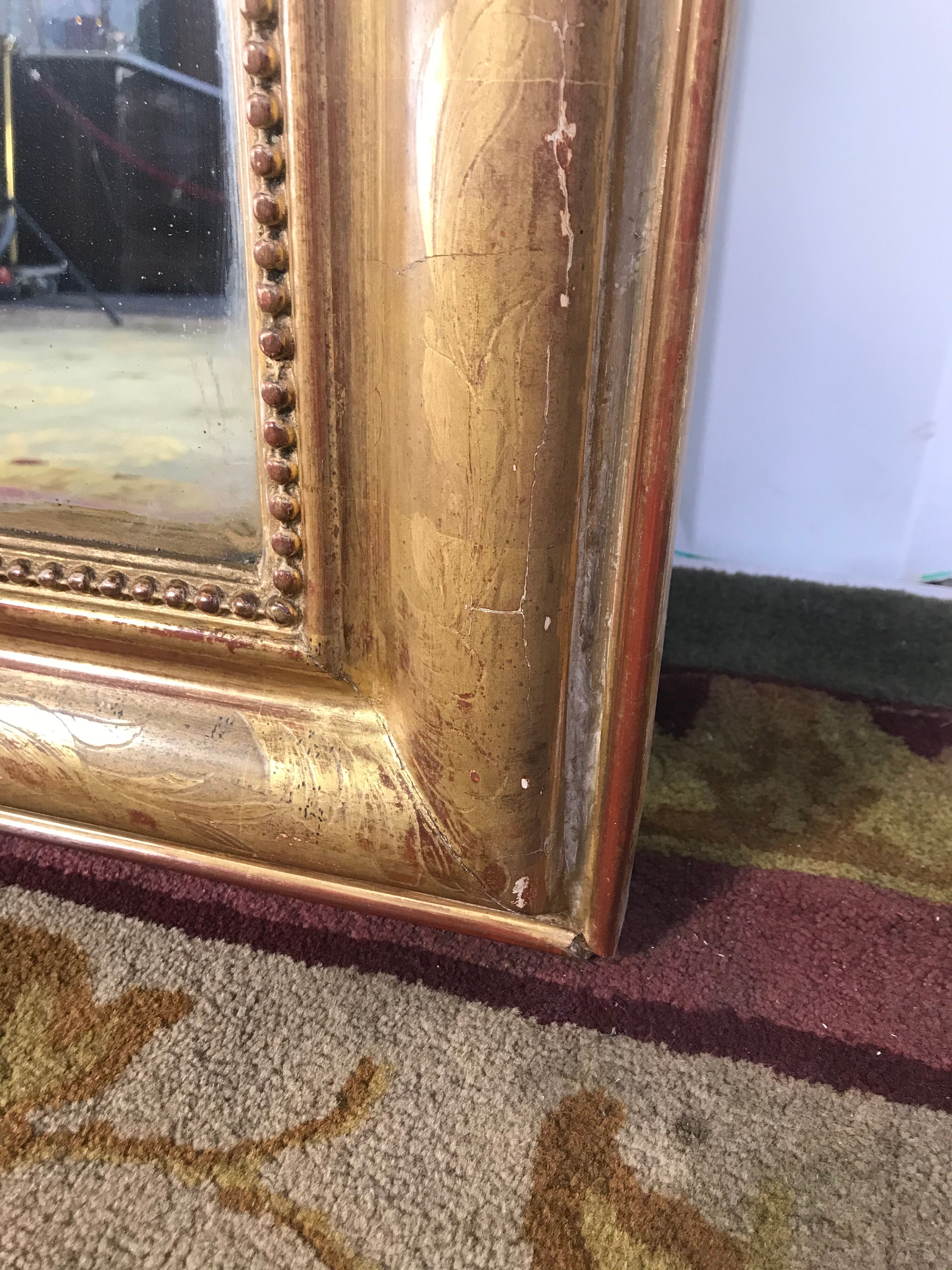 Louis Philippe's era mirror with a gold leaf pediment