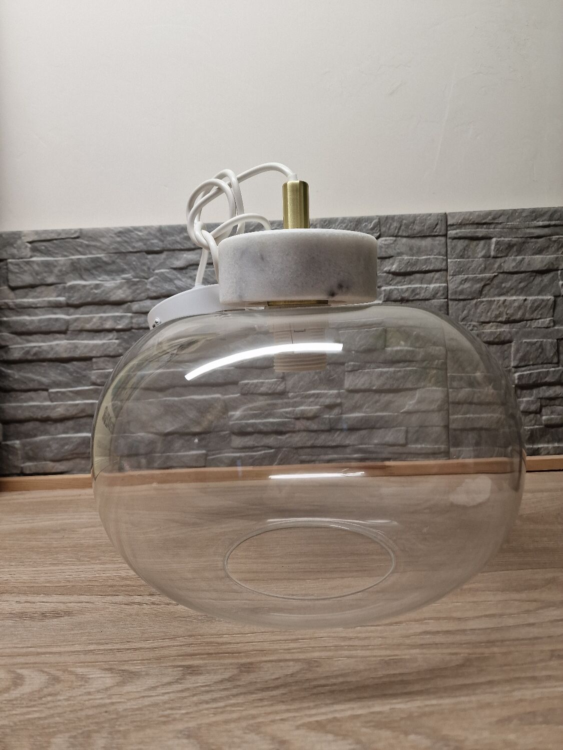 Glass globe pendant light with marble