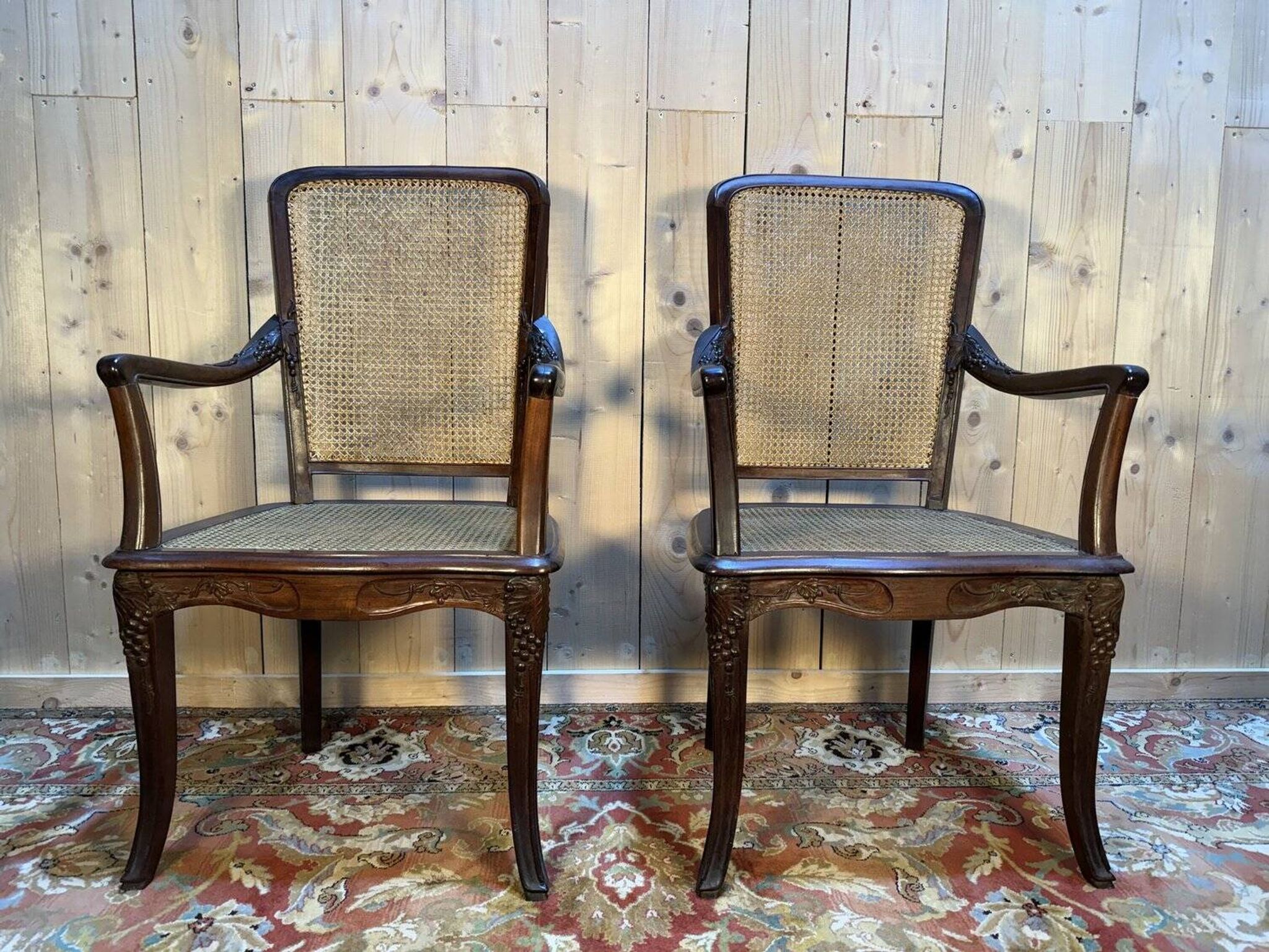 Pair of wide caned armchairs from the Art Nouveau period.