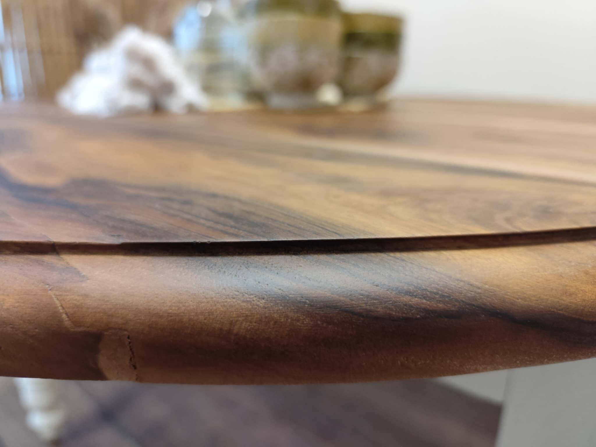 Round walnut table convertible into a console.
