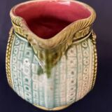 Small onnaing barbotine jug with lion decoration
