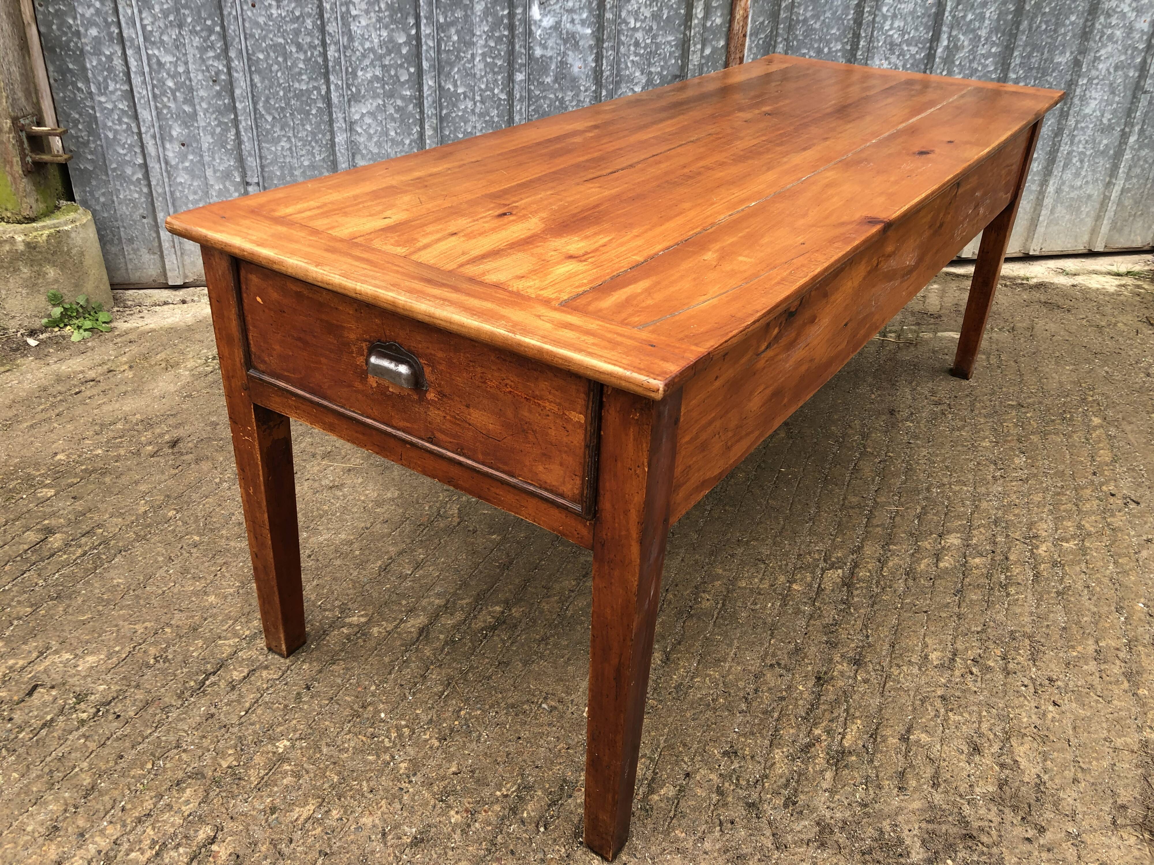 Antique farmhouse table in solid cherry wood with 3 drawers and 1 pull-out.