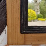 Black mirror and raw natural wood