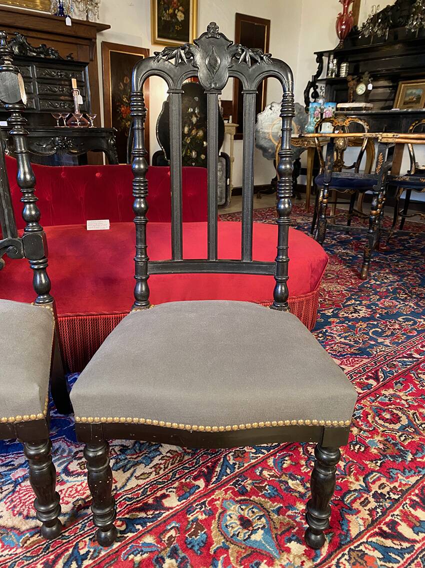 Fake pair of low Napoleon III chairs in blackened wood.