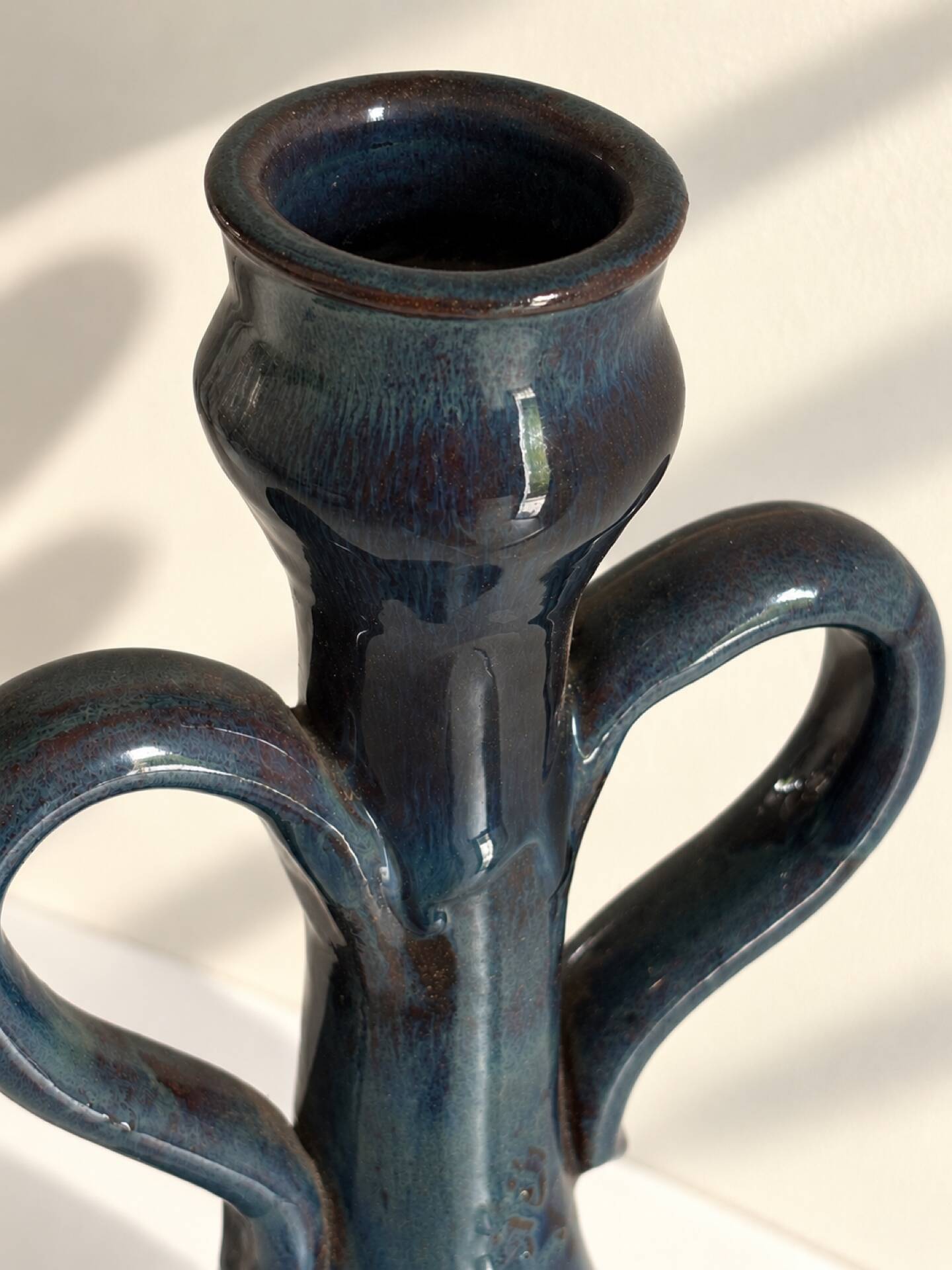 Decorative deep blue glazed ceramic vase with twin handles.