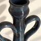 Decorative deep blue glazed ceramic vase with twin handles.