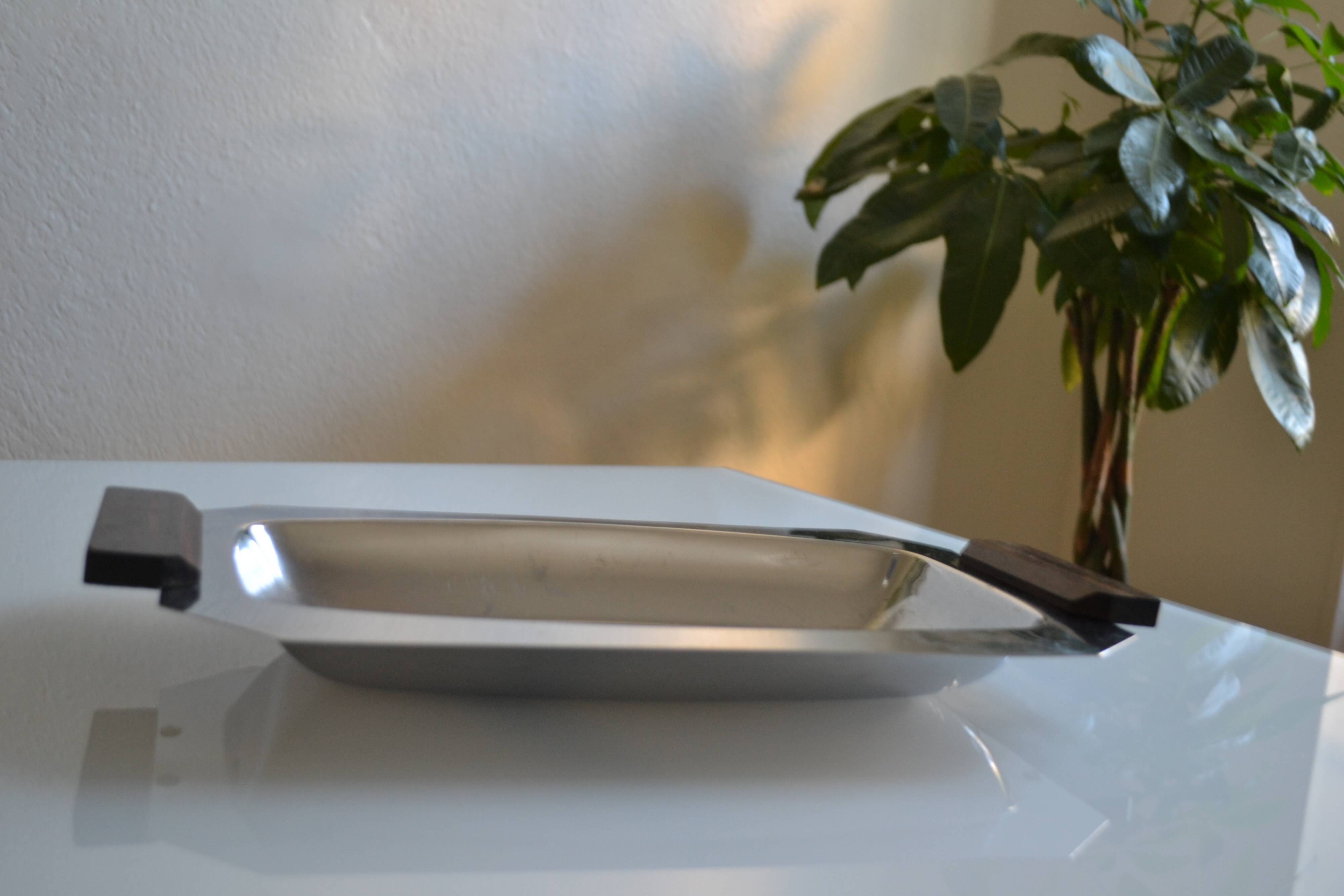 Art Deco serving dish in chrome metal with ebony handles.