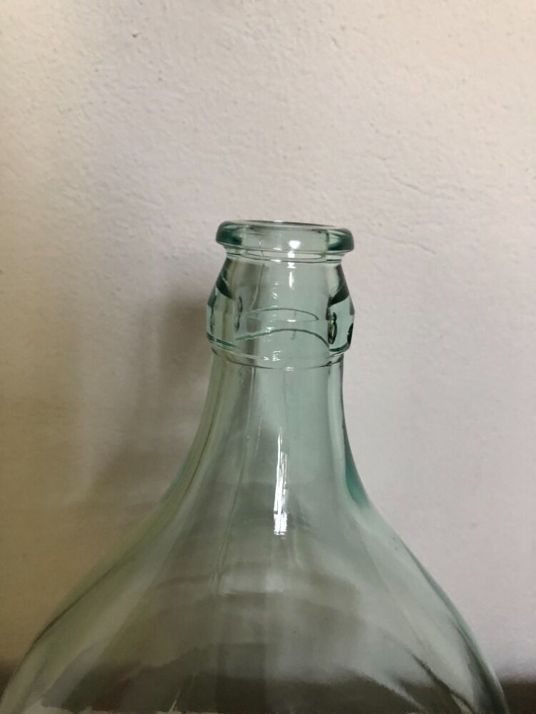 Demijohn in glass with light blue reflection