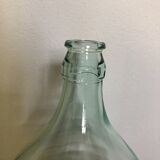 Demijohn in glass with light blue reflection