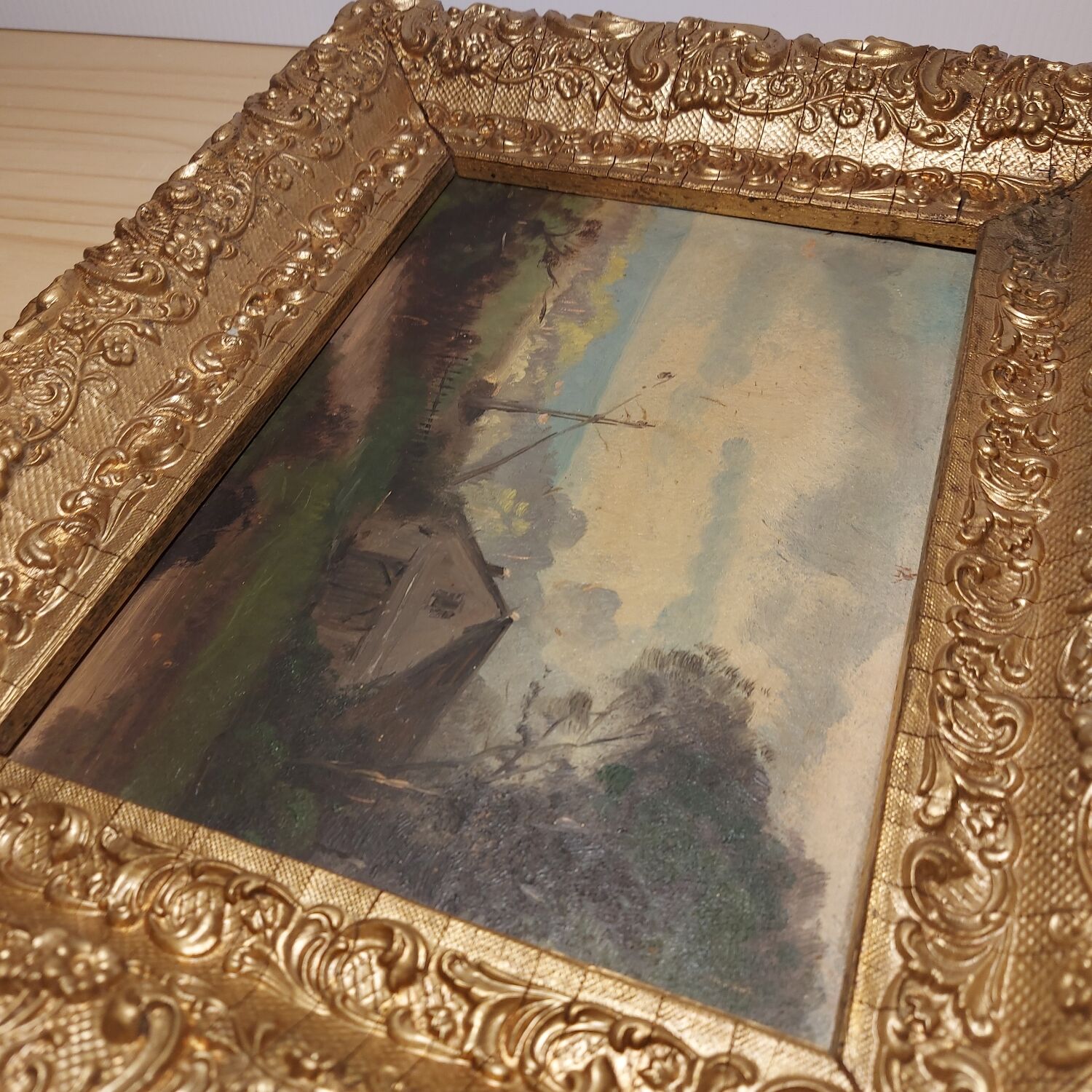 Oil on framed panel depicting a country house