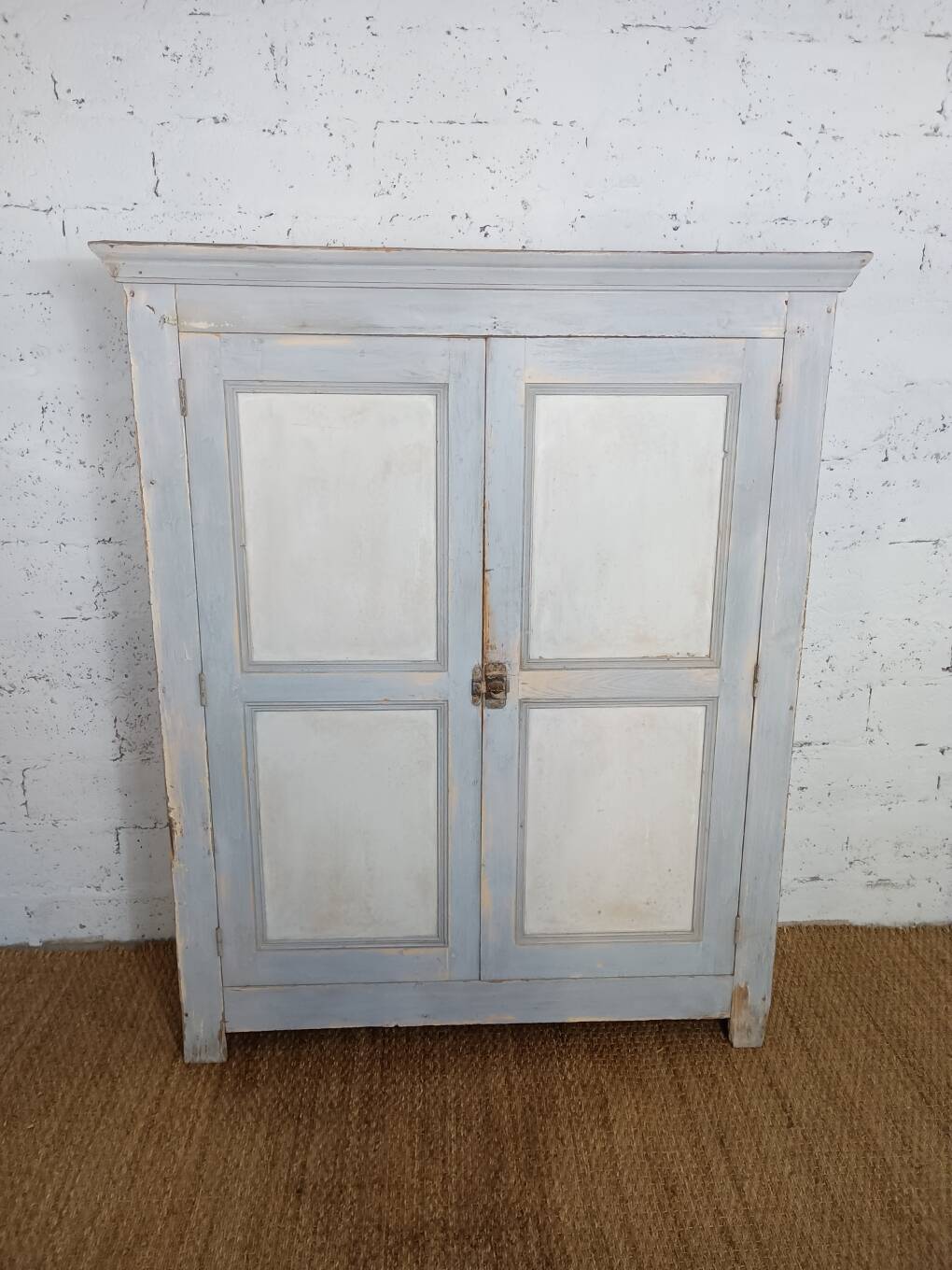 Low Parisian wardrobe with two doors, made of fir with original patina