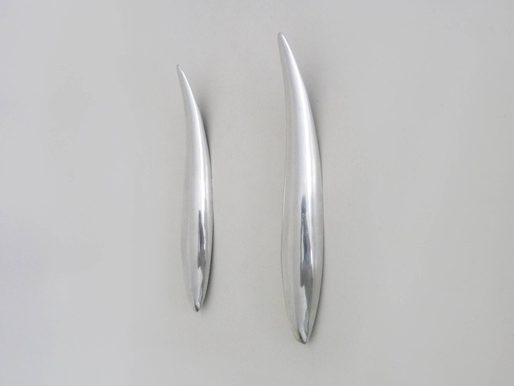 Pair of designer wall sconces in aluminium in the style of Lucien Gau.