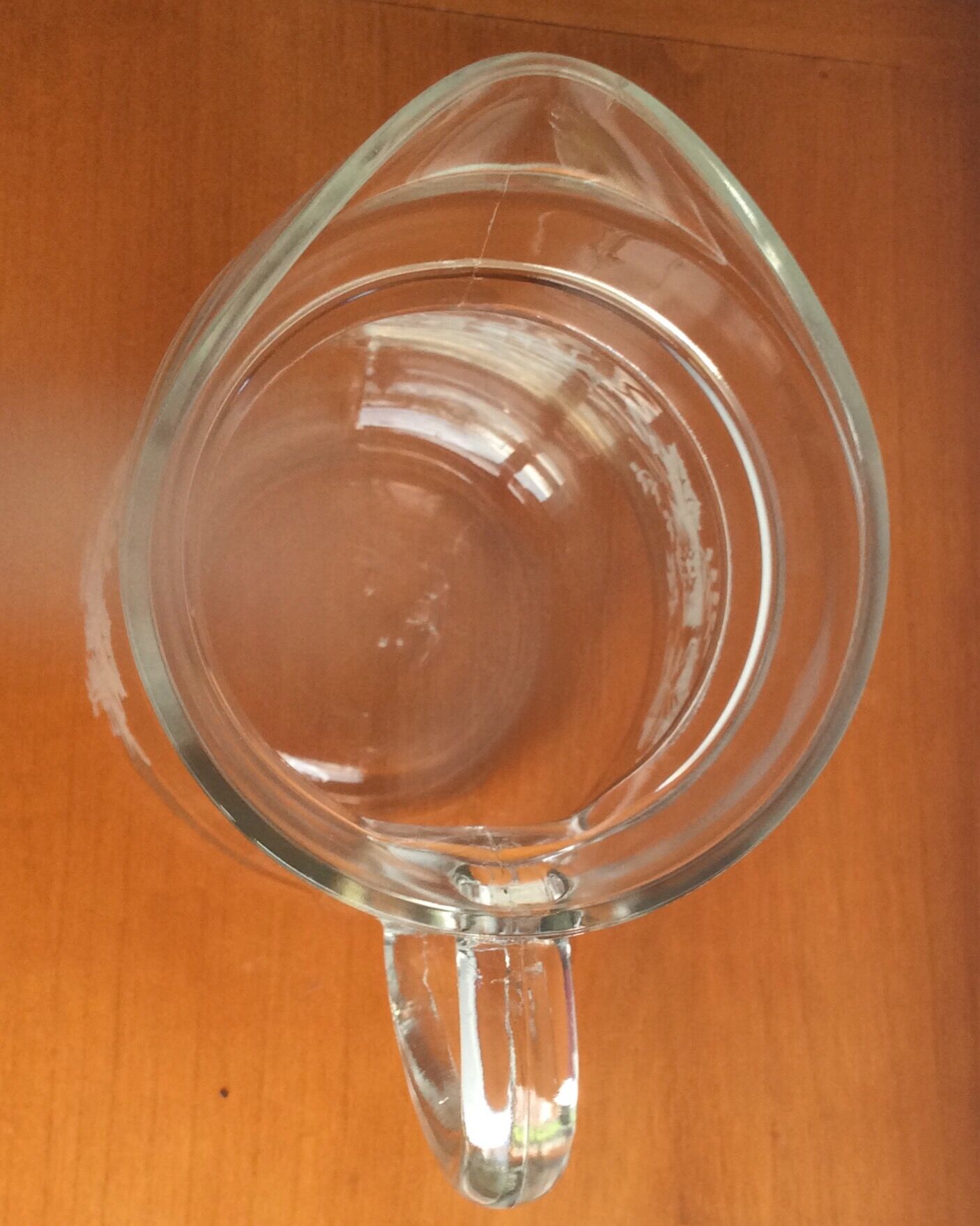 Old glass water pitcher with white flowers in relief with gold edging