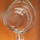Old glass water pitcher with white flowers in relief with gold edging
