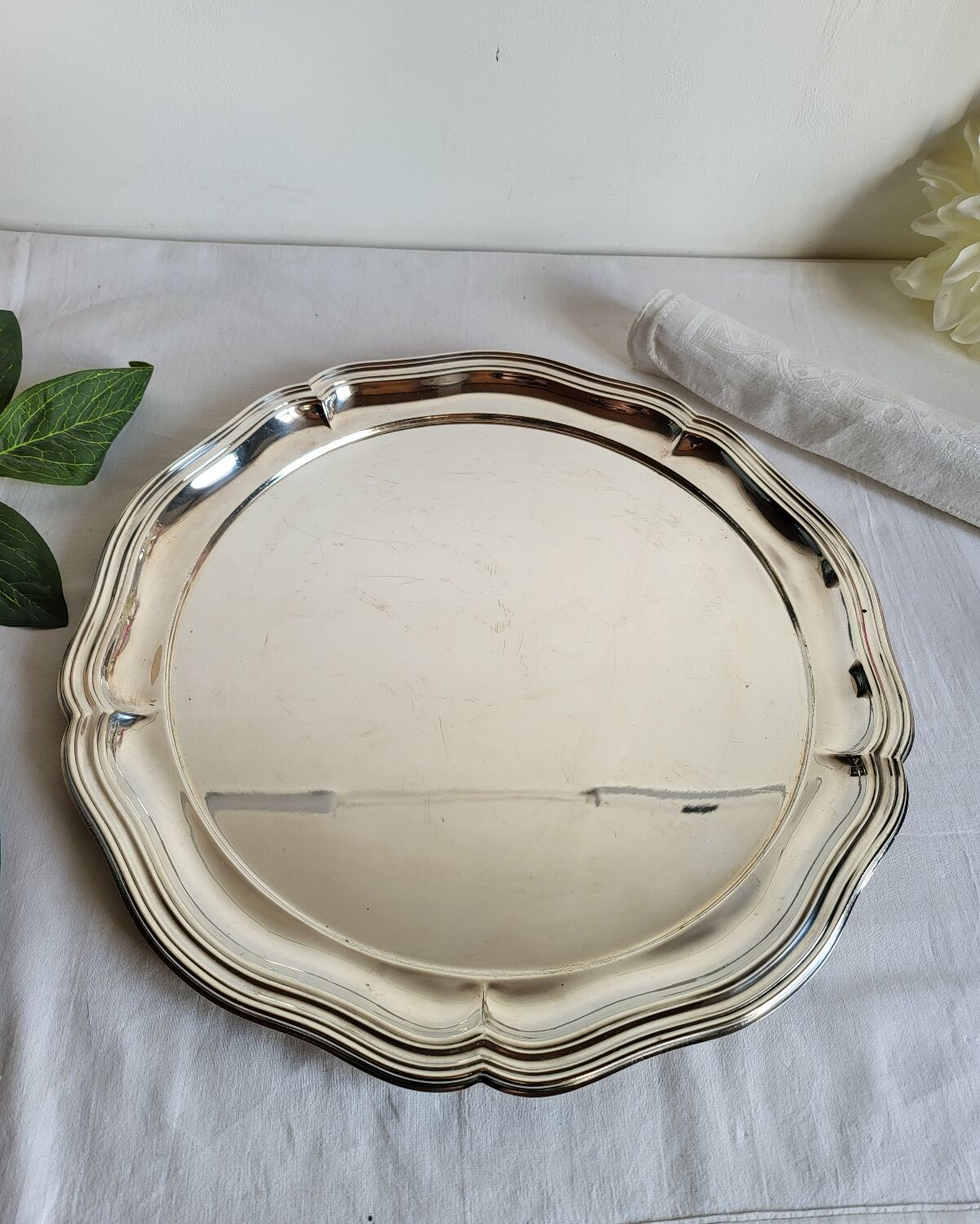 Round silver-plated serving dish with a glass base.