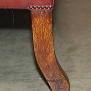 Victorian Chesterfield leather sofa with carved lion heads.