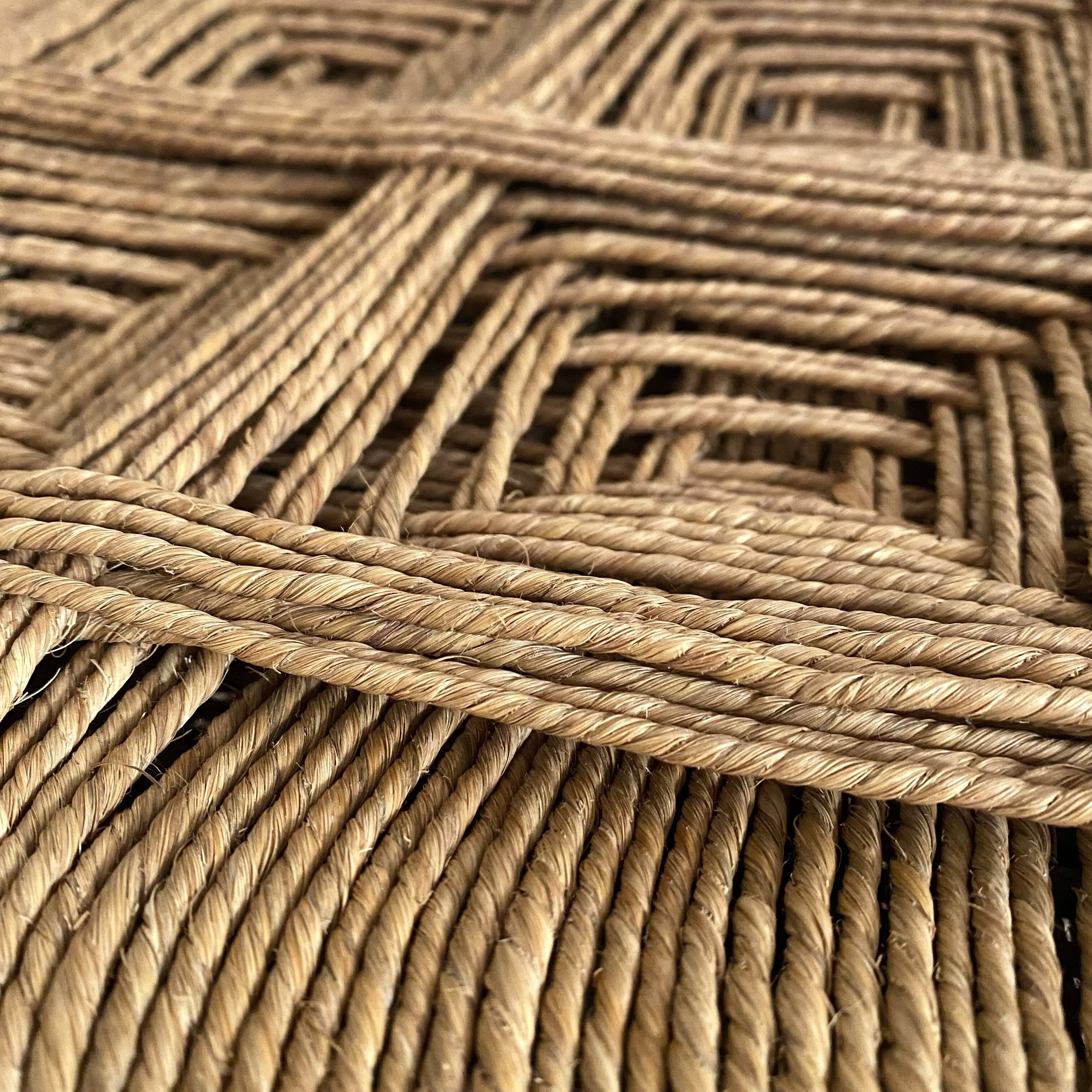 Low stool with carved wood and braided cord.