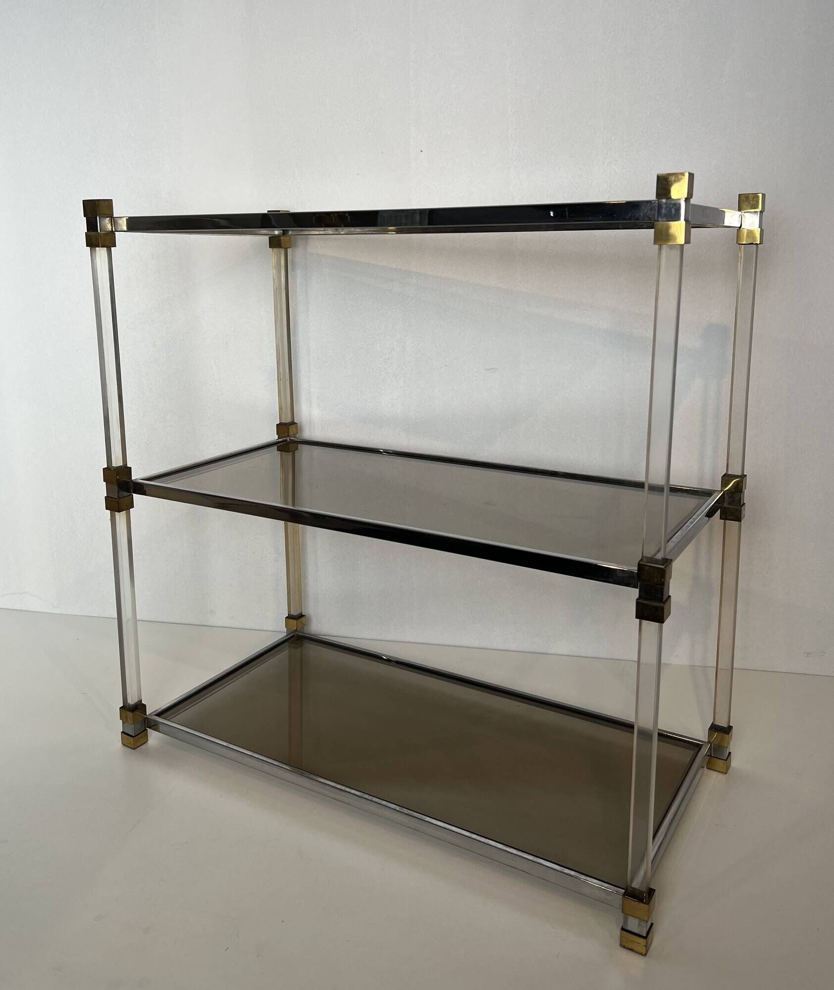 Lucite Shelf with Three Smoked Glass Shelves and Brass Ends. Work