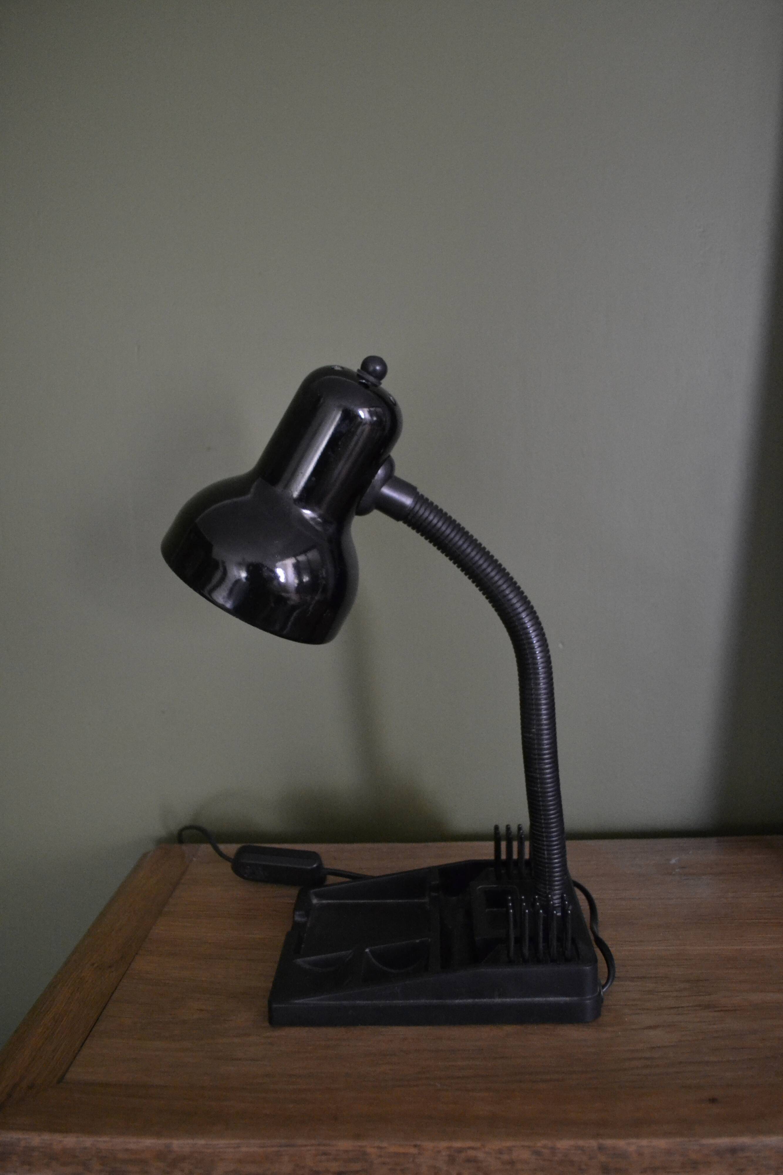 Black flexible desk lamp with built-in flashheld