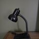 Black flexible desk lamp with built-in flashheld