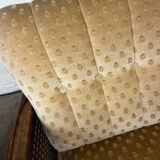 Vintage wooden armchair with rattan weaving.