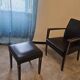 Armchair and faux leather footrest