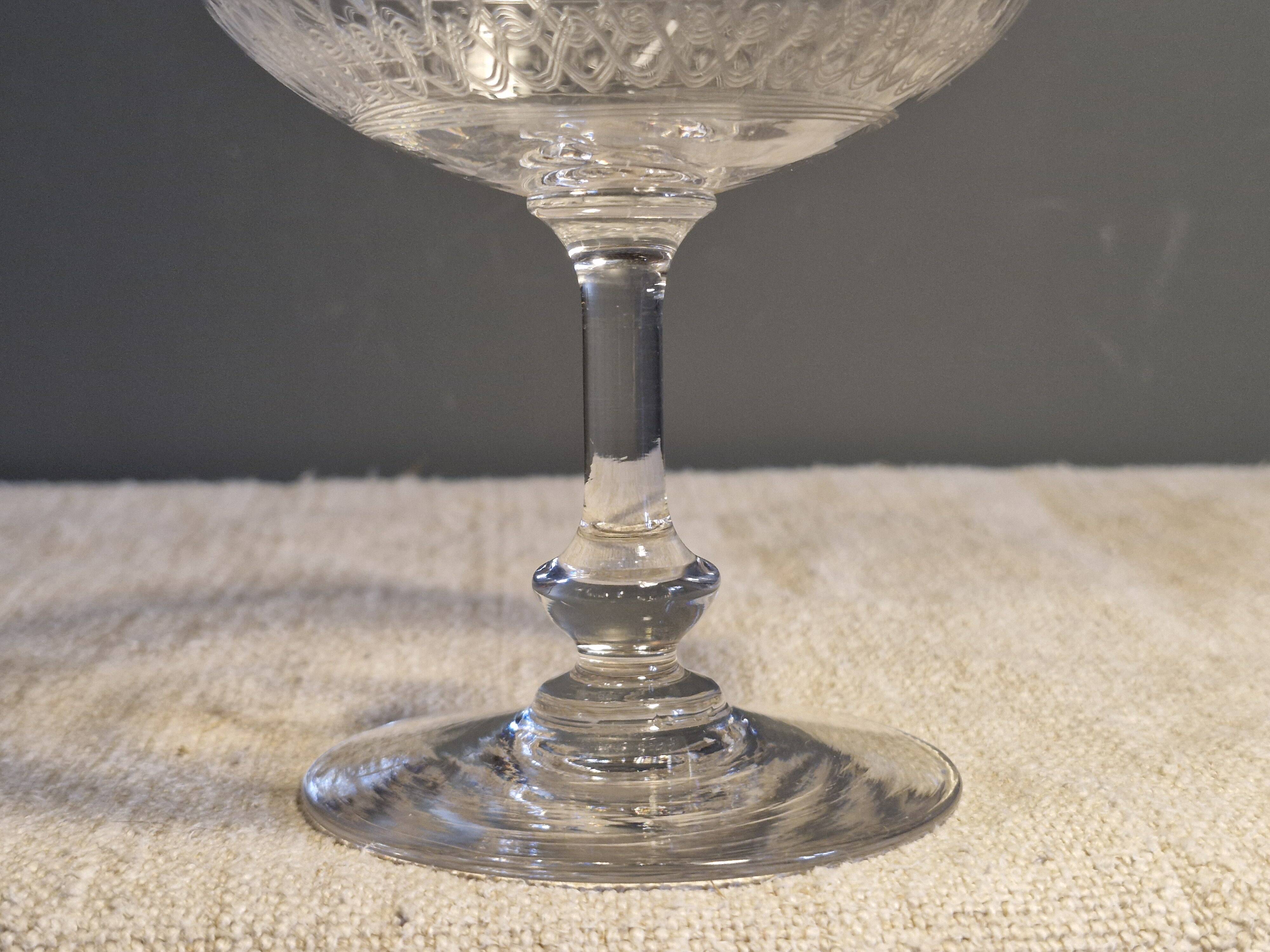 8 antique Baccarat crystal champagne coupes with engraved decoration.