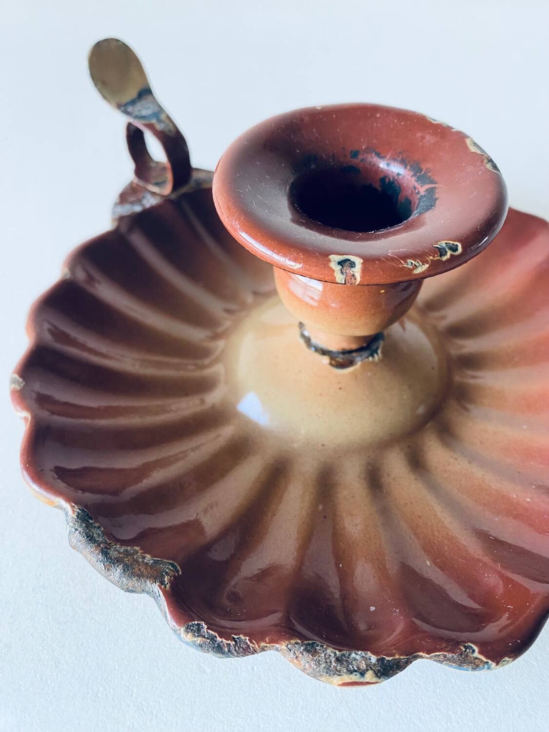 Old candle holder in brown enameled metal