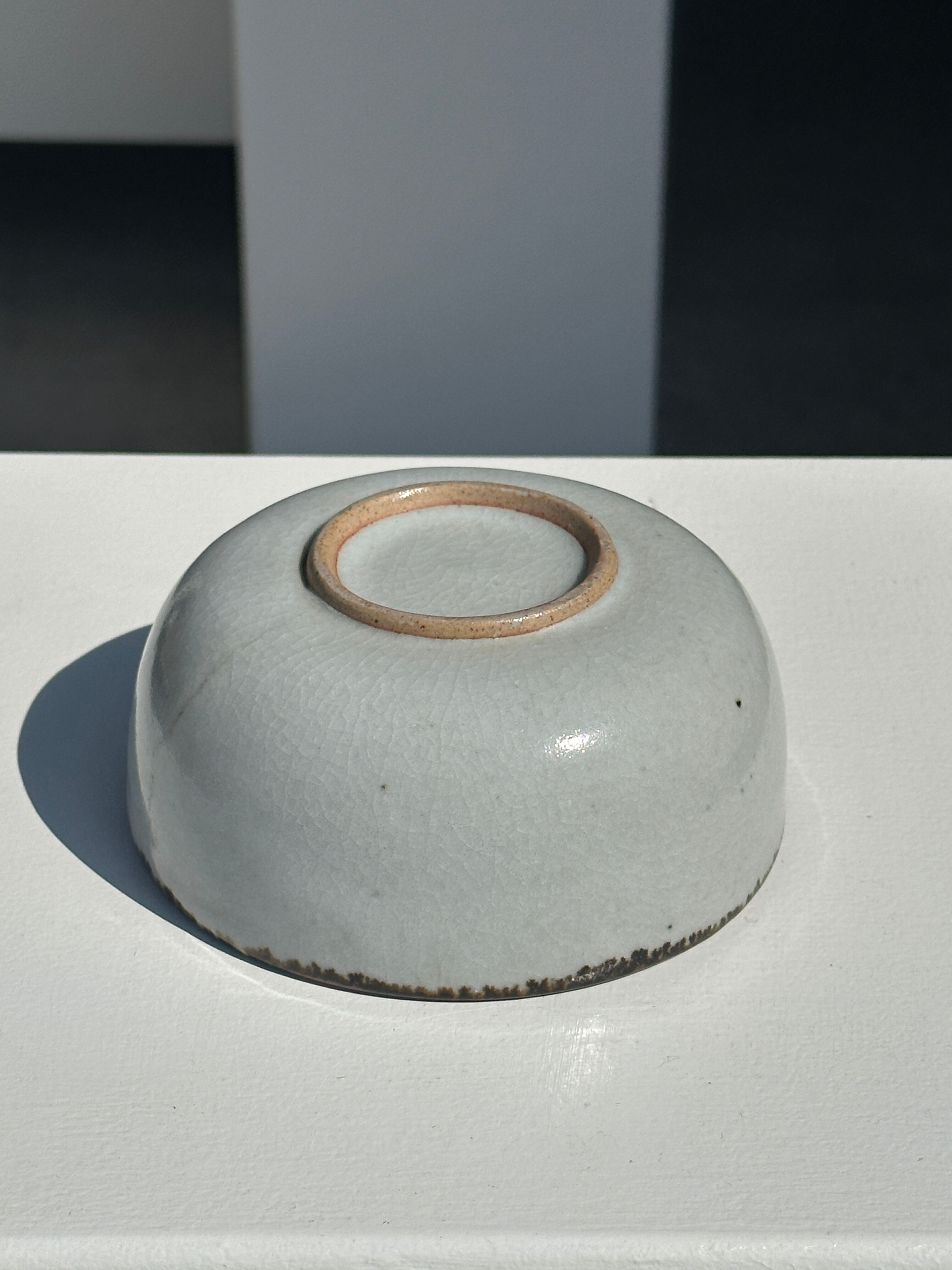 Small white glazed ceramic bowl black edges