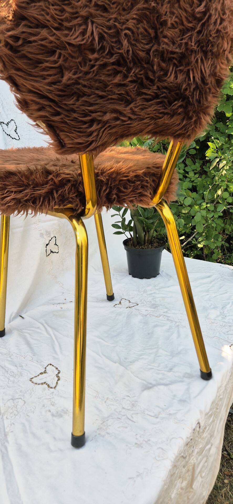 Vintage shaggy chair in faux fur with golden metal legs.