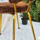 Vintage shaggy chair in faux fur with golden metal legs.