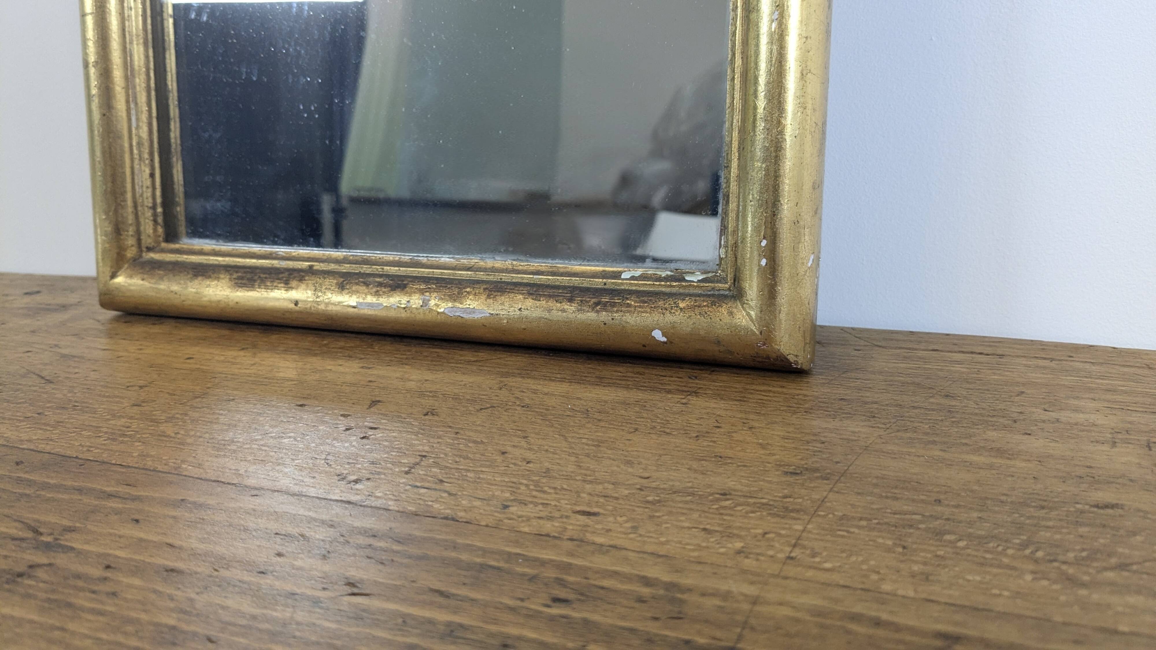 Antique gold mirror known as "gendarme's hat", patinated elegance 70 x 30 cm