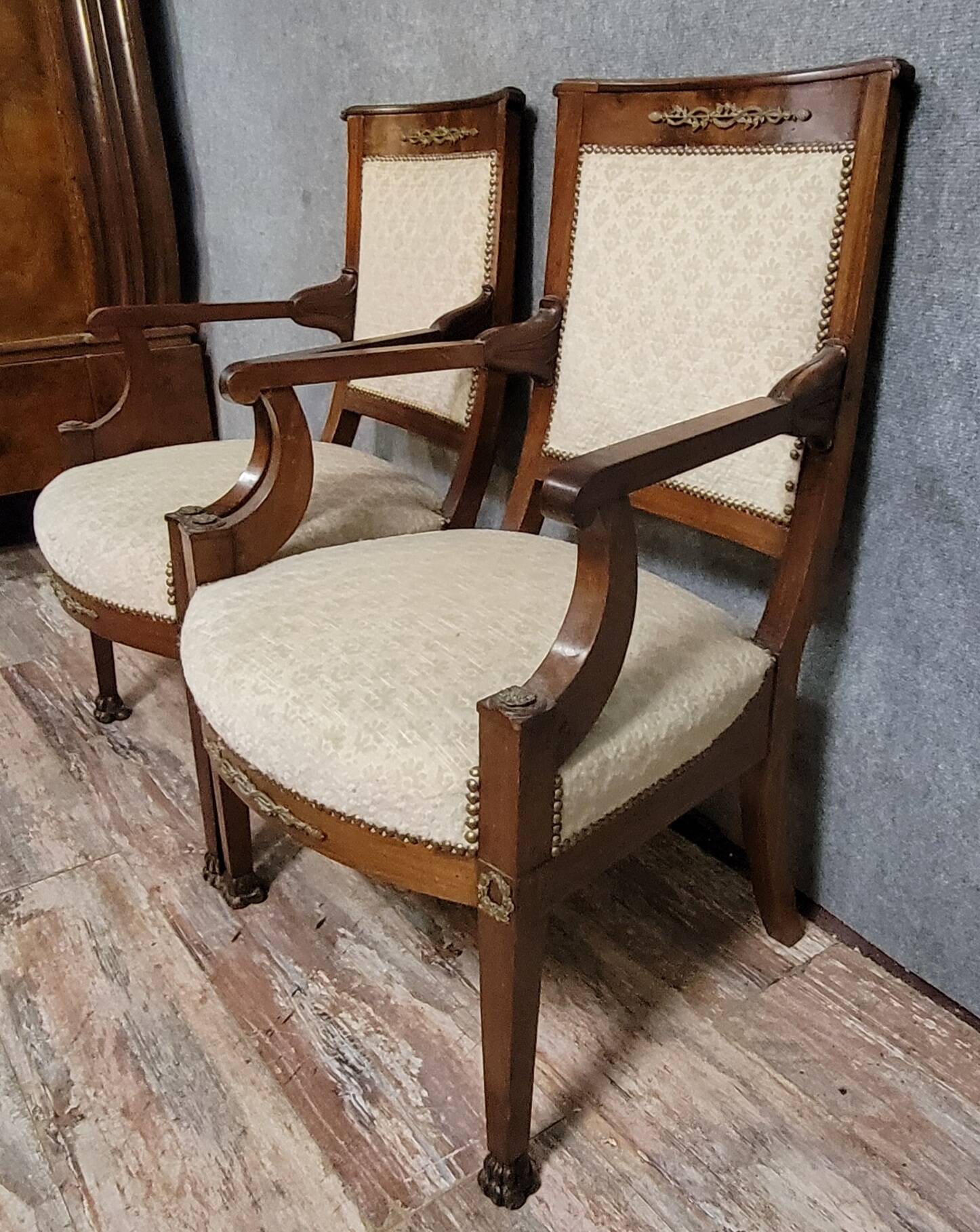 Pair of Empire period armchairs, in mahogany and gilded bronze.