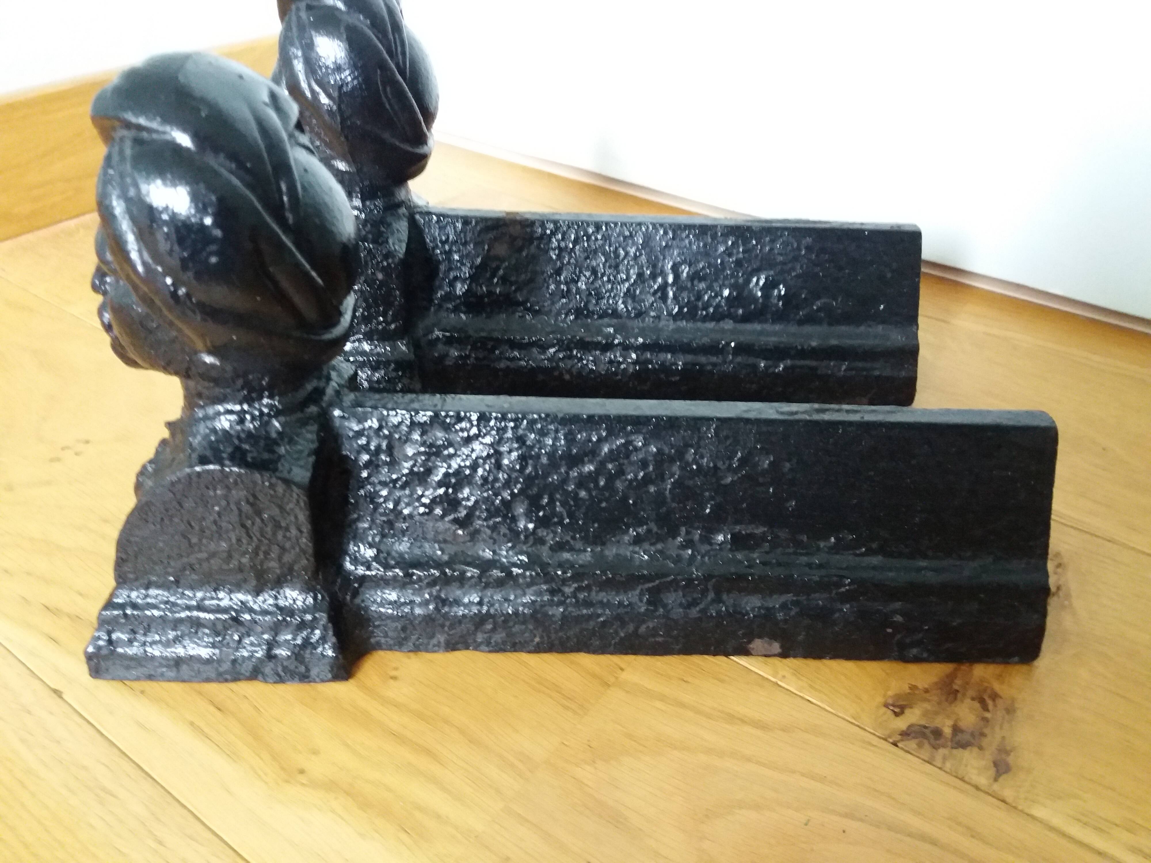 Cast iron andirons with character heads