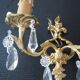 Pair of gilt bronze wall sconces with crystal pendants.